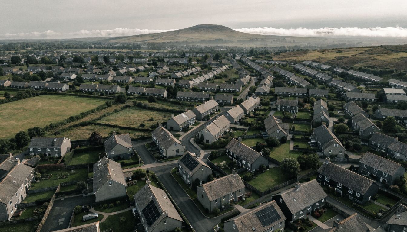 Aerial view of a housing estate with several solar-panelled roofs